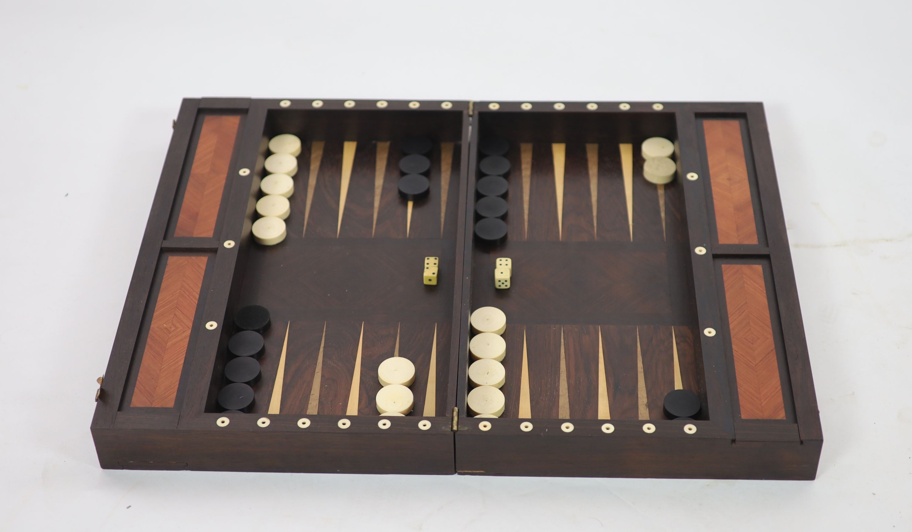 An early 20th century rosewood folding games board, external chess and internal backgammon, W 75cm D 56cm when open, W 75cm D 37cm when closed